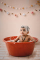 Baby sitting in a bathtub with bubbles
